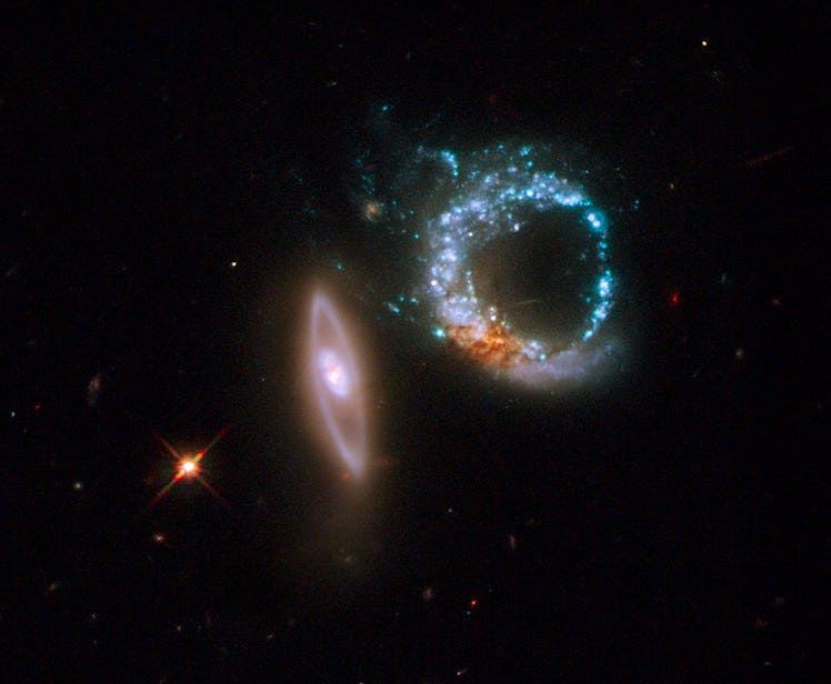 Color photo of two bright circles of stars with open centers, at different angles to each other.