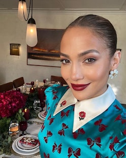 Jennifer Lopez wearing a turquoise Gucci dress for Christmas 2022.