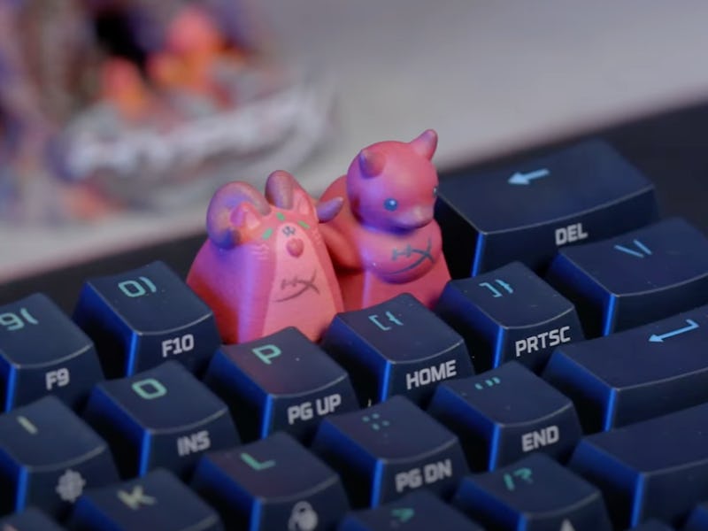 Two HX3D custom keycaps.
