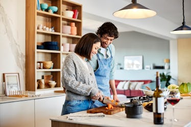 A couple cooking together in the kitchen in order to help their feelings of being distanced from eac...