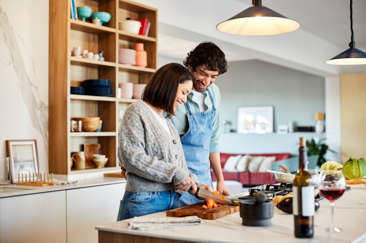 A couple cooking together in the kitchen in order to help their feelings of being distanced from eac...