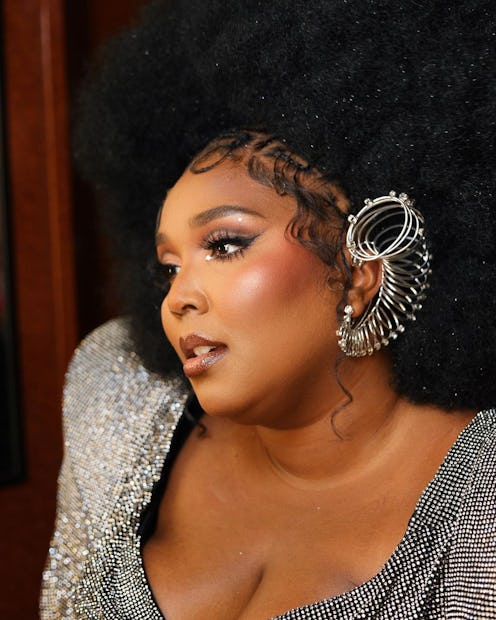 Lizzo with Afro, ear cuff, and rosy blush