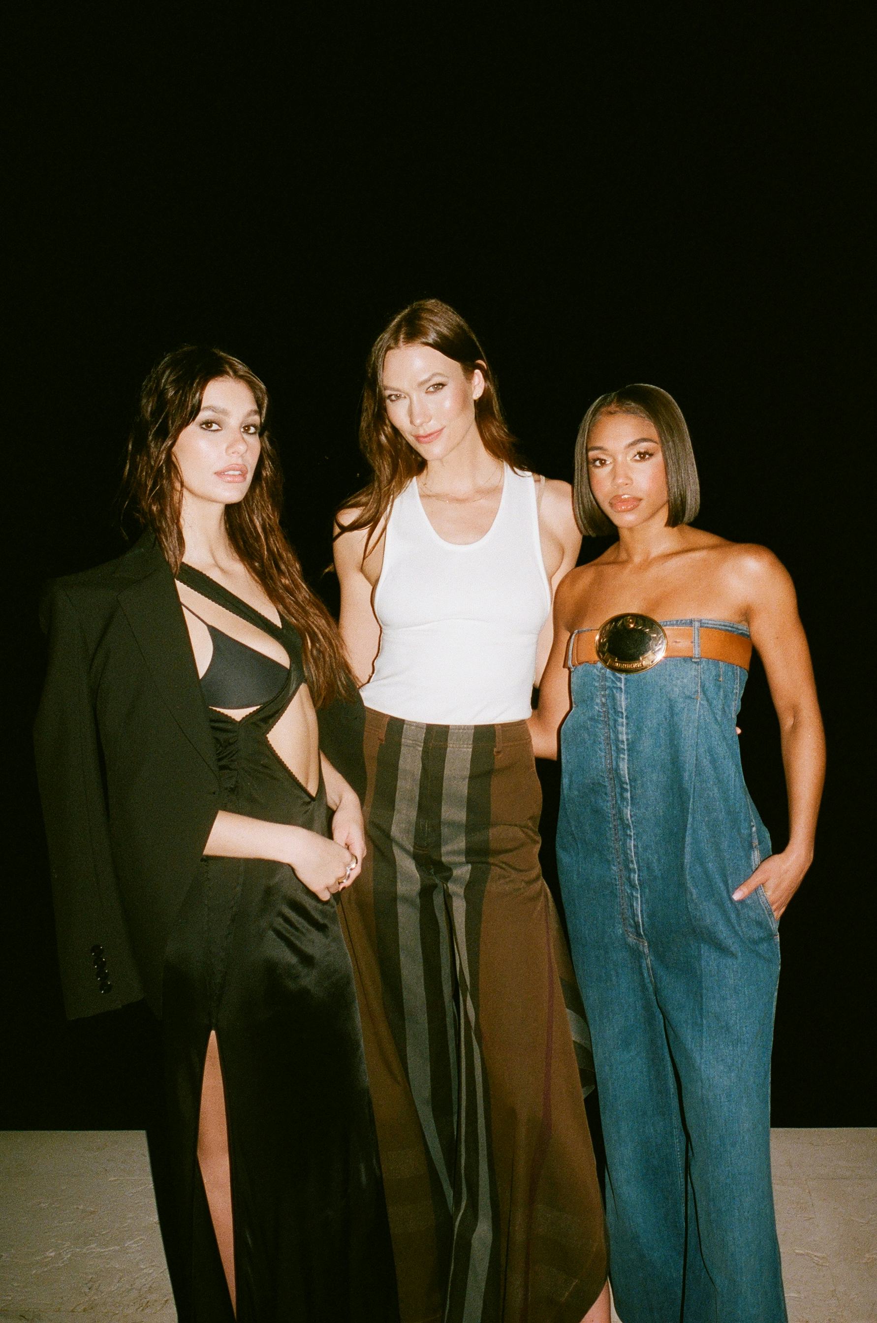 Camila Morrone, Karlie Kloss, and Lori Harvey smizing at the camera
