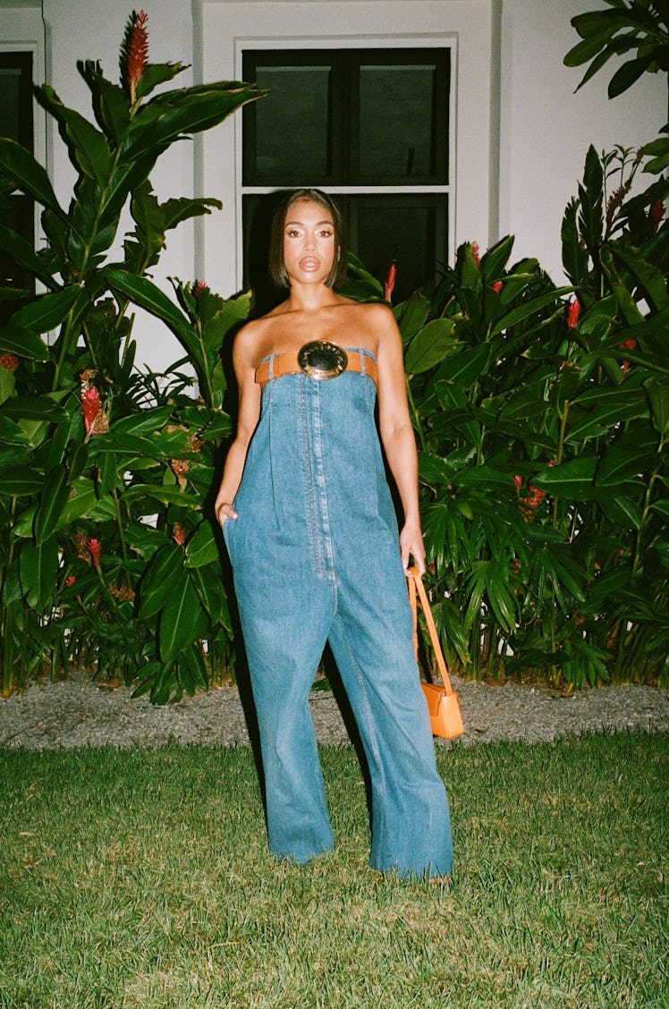 Lori Harvey wearing Burberry jeans that are a dress and a belt