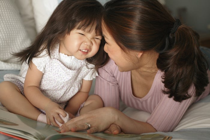 mom reading book to little girl