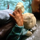 A child sleeping while holding a stuffed animal.