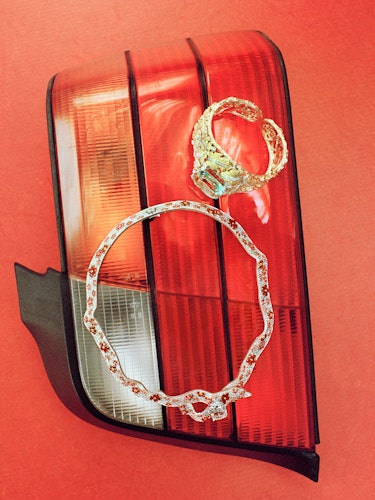 diamond jewelry laid on a car tail light