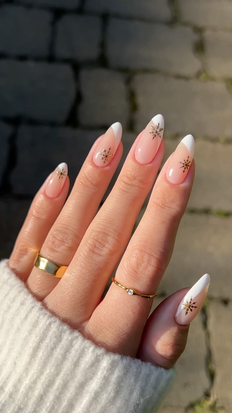 The best Christmas press-on nails in 2022 have French tips and snowflake decals.