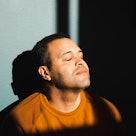 Man trying to be calm closing his eyes and taking in sunlight