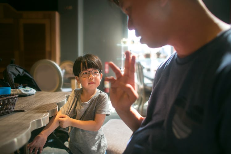 A dad punishing his son.