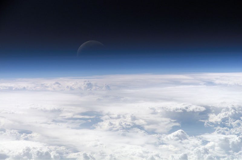 color photo of the upper bounds of Earth's atmosphere fading into the dark of space