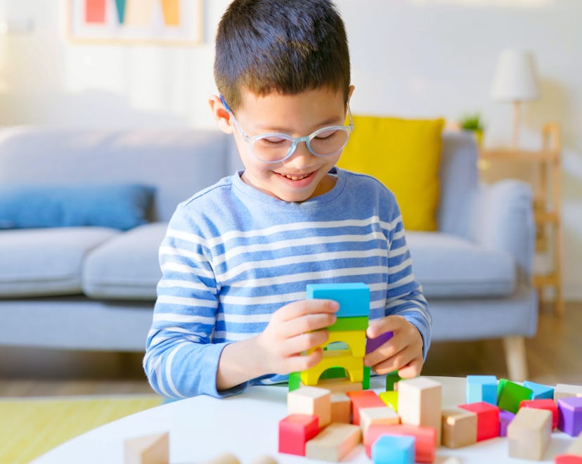 close up of asian boy with building blocks, one of the best toys for 4 year olds