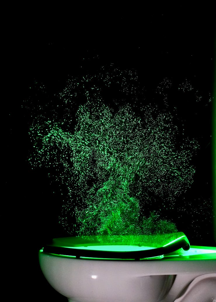 An image of a laser trained on a flushing toilet.