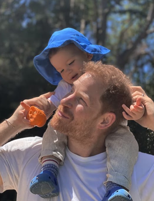Prince Harry with Archie on his shoulders.