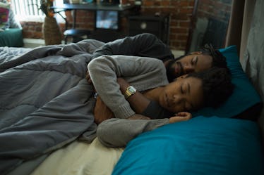 A couple sleeping in bed.