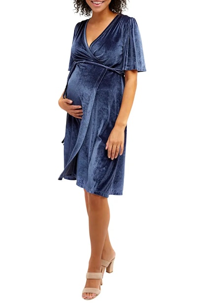 Blue velvet maternity wrap dress on model