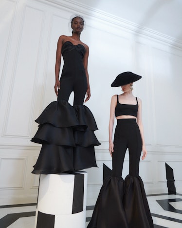 two models wearing all black looks from Carolina Herrera's pre-fall 2023 collection