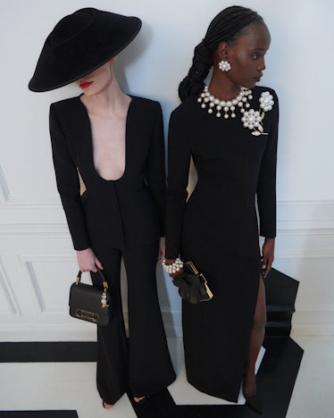 two models in all black looks from Carolina Herrera's pre-fall 2023 collection