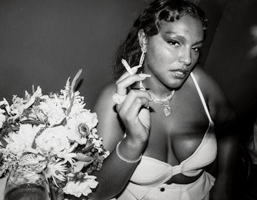 Model Paloma Elsesser smokes a cigarette at an afterparty.