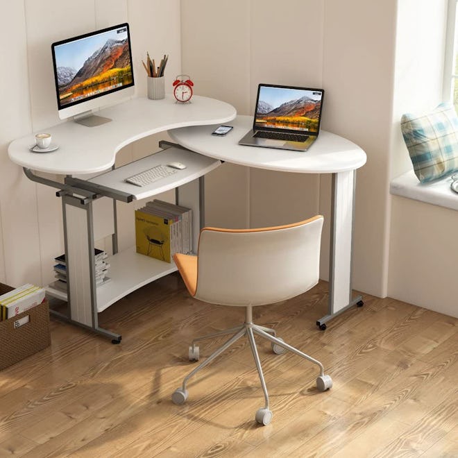 This corner desk for small spaces has a side table that rotates out for more workspace.