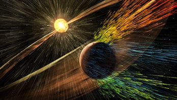 Illustration with Mars in the foreground, having its atmosphere blown away by stellar wind from the ...