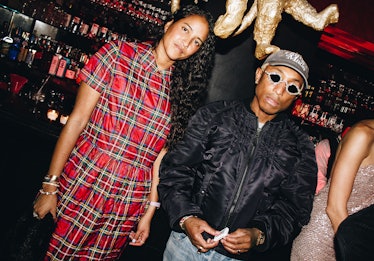 Pharrell Williams & his wife photographed at W's party.
