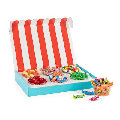 A red and white striped box with six varieties of candy inside