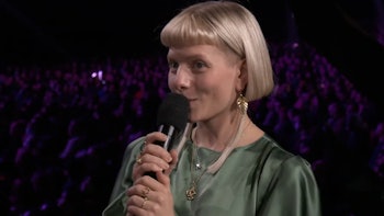 Aurora speaking into microphone at Game Awards