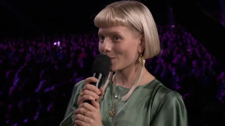 Aurora speaking into microphone at Game Awards