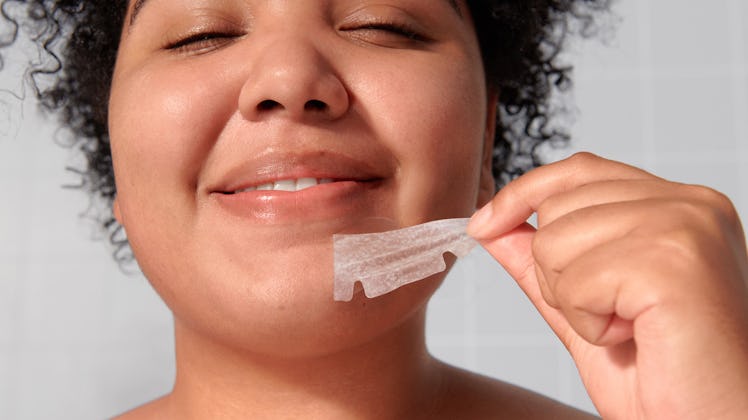 A woman rips off a Mighty Patch Chin pimple patch