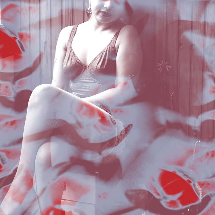 An abstract image of a woman sitting in lingerie with a red-burgundy color filter effect