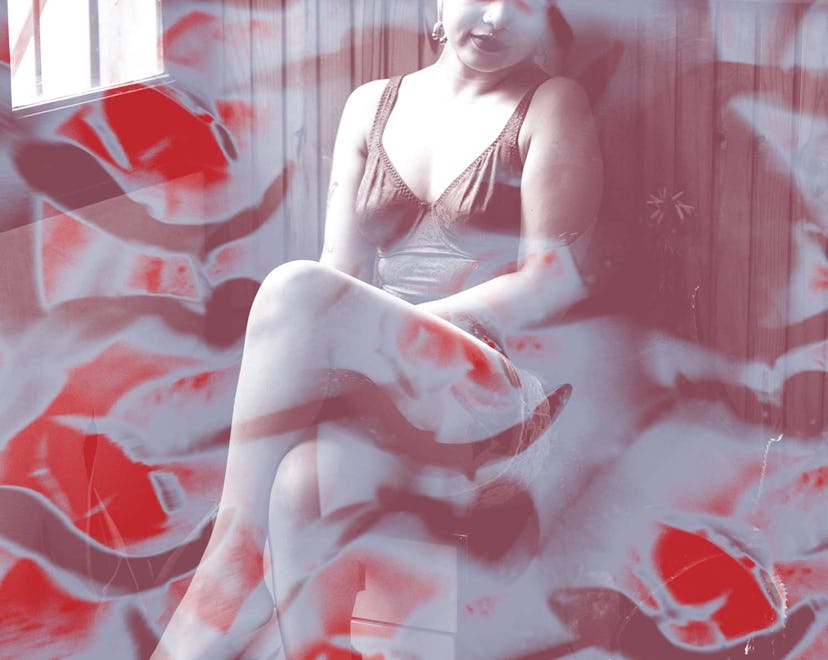 An abstract image of a woman sitting in lingerie with a red-burgundy color filter effect