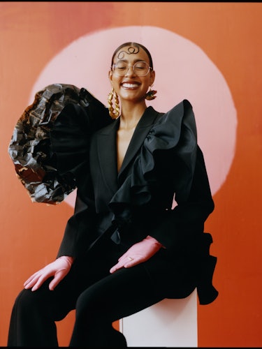 the gallerist hannah traore wearing a black suit and smiling