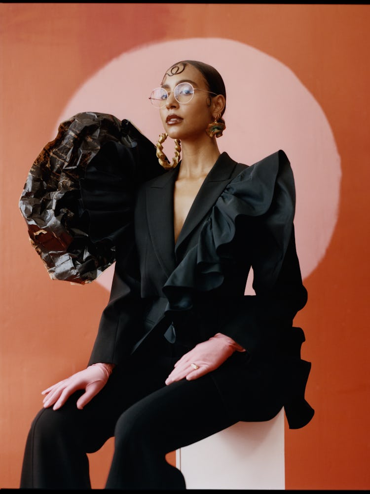 the gallerist Hannah Traore wearing a black suit