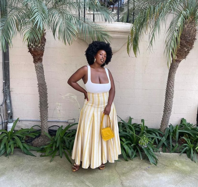 Influencer Mecca James-Williams wearing a yellow EDAS bag.