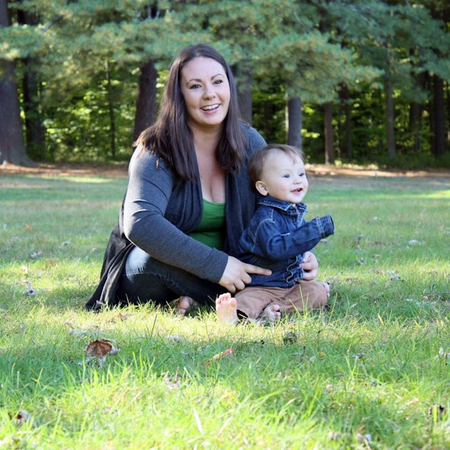 Corinne and her son sit on the grass.