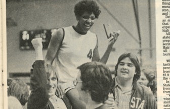 A segment of an old newspaper page with 'The Queen of Basketball' Lucy Harris talking to a group of ...