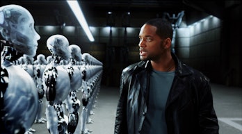Will Smith stands in front of a line of robots