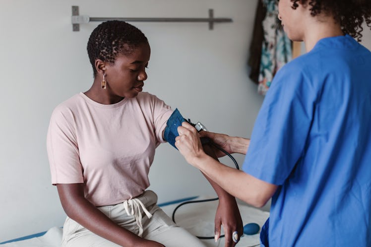 woman having her blood pressure checked