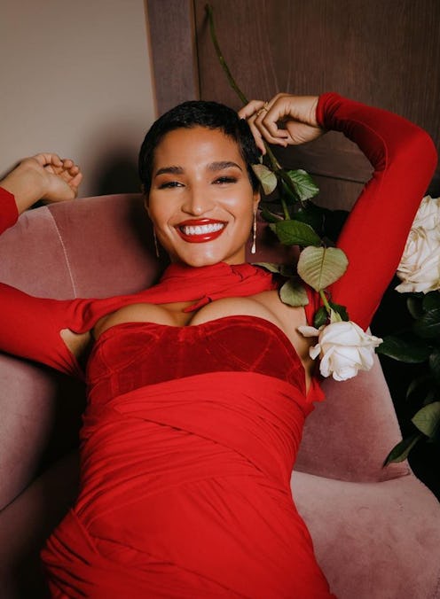 Indya Moore laying down with roses