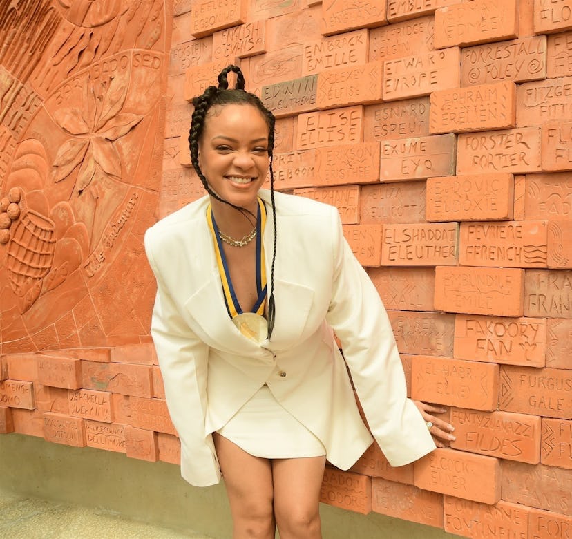 Rihanna wears pastel yellow blazer and miniskirt.