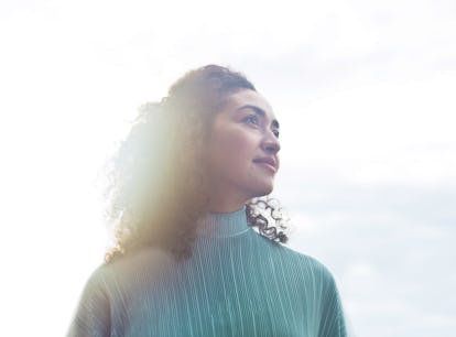 Young woman in sunlight, ready to find out the spiritual meaning of the February 2022 full Snow Moon...