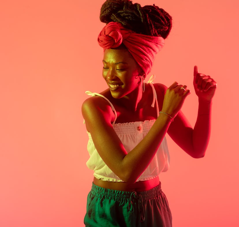 Young woman dancing and celebrating the emotional meaning of the February 2022 full Snow Moon in Leo...