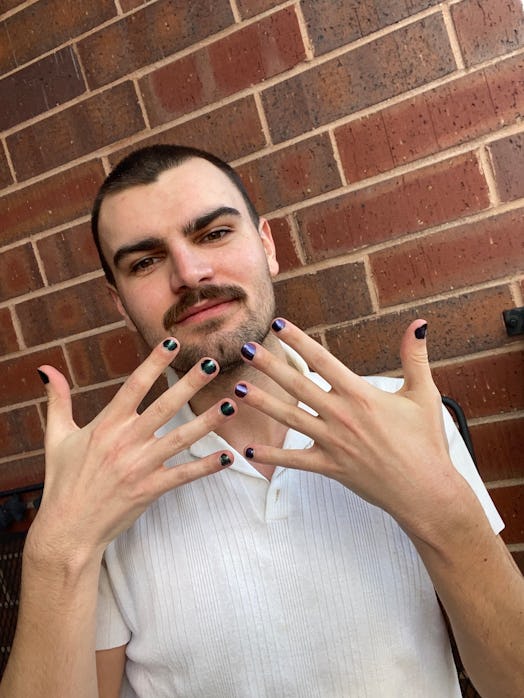 Elite Daily Editor Joseph Longo wearing UN/DN LAQR's Orion purple nail polish.