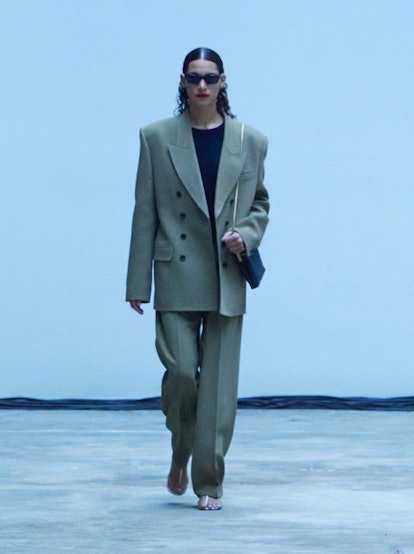 A model is wearing an oversized beige suit from Khaite's Fall/Winter 2022 Collection.