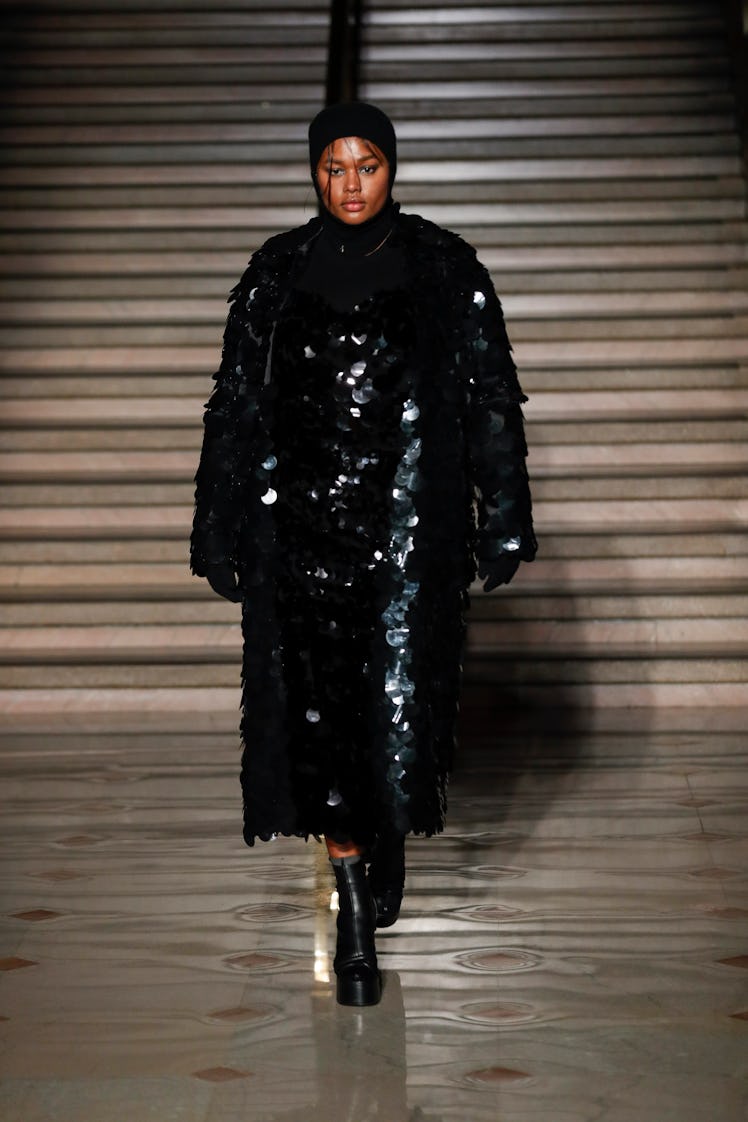 Model on the NY Fashion Week Fall 2022 runway in an Altuzarra black sequined coat