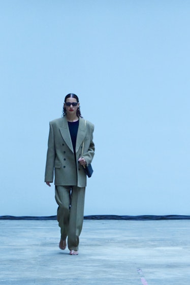 Model on the NY Fashion Week Fall 2022 runway in a Khaite gray suit