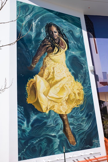 A mural of a person wearing a yellow Christopher John Rogers dress by Calida Rawles