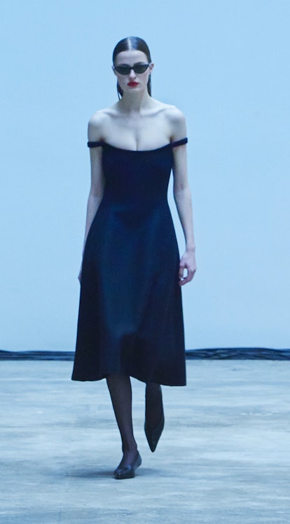 A model is wearing a black sleeveless dress with a sweetheart neckline from Khaite's Fall/Winter Col...