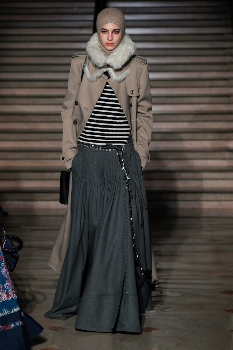 Model on the NY Fashion Week Fall 2022 runway in an Altuzarra gray coat, white and black striped shi...